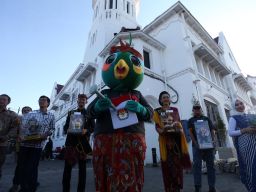 Maskot Pilkada Jatim 2024 Si Jalih atau Jatim Memilih bersama Raka Raki Jatim, serta komisioner dan staf KPU Jatim  di kawasan wisata Kota Lama Surabaya