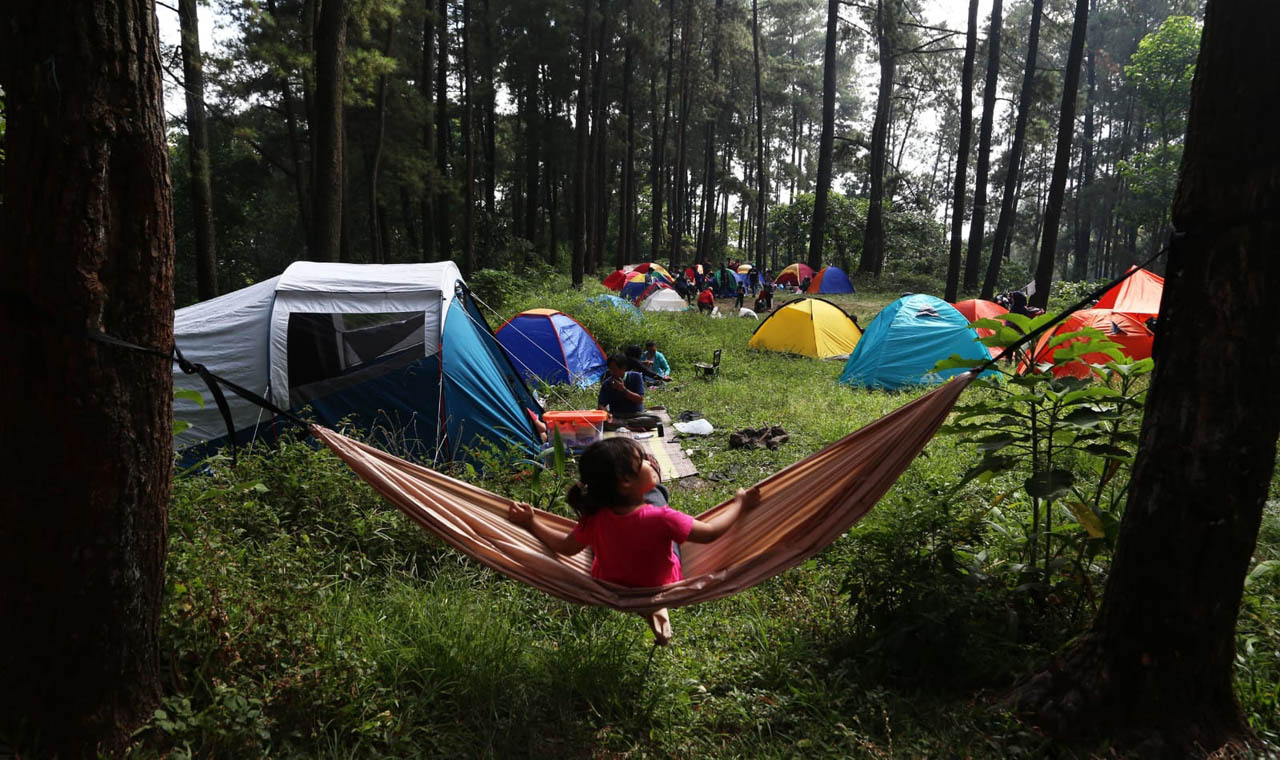 Ajak si kecil merasakan pengalaman berkemah yang unik dan menyenangkan dengan glamping di tengah indahnya alam pegunungan. Foto/Alim Perdana